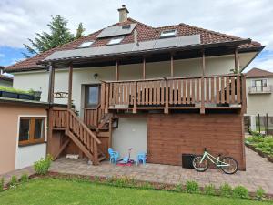 a house with a deck and a bike on a patio at Vila Vannet II in Liptovský Mikuláš
