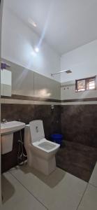 a bathroom with a toilet and a sink at Bro Code Marayoor A Premium Family Friendly Retreat with Panoramic Mountain Views in Maraiyūr +59 photos