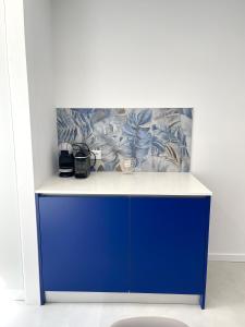 a blue cabinet in a room with a wall at Casa das Abelhas in Arcos de Valdevez