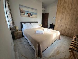 a bedroom with a bed with a white bedspread at Maitos Apartments in Galanádhon