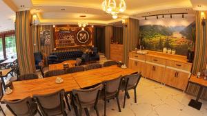 a conference room with a large wooden table and chairs at Meric Hotel in Uzungöl
