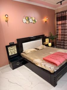 a bedroom with a large bed in a room at Meraki Homes in Karnal