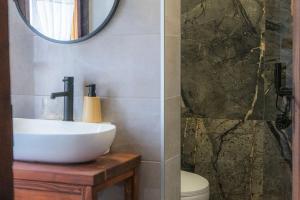 a bathroom with a white sink and a mirror at Конак Буката in Bukata