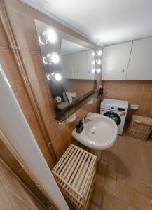 a small bathroom with a sink and a mirror at Central Family Flat Volos in Volos