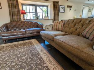 a living room with two couches and a couch at Stable Lodge in Berwick-Upon-Tweed
