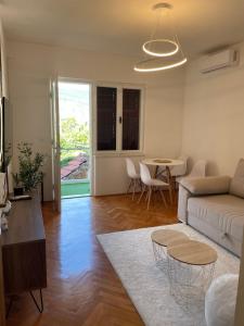 a living room with a couch and a table at Apartmani Cicibela in Herceg-Novi