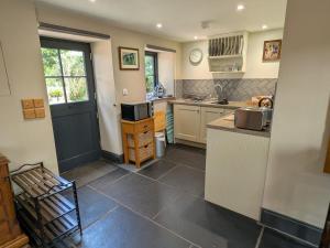 a kitchen with a sink and a counter top at Stable Lodge in Berwick-Upon-Tweed