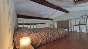 a bedroom with a bed and a table with a lamp at La Santoline - Provençal break with pool in Le Thor +34 photos