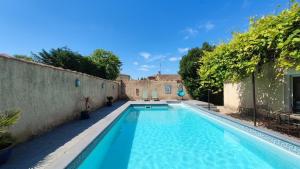 a swimming pool in the backyard of a house at La Santoline - Provençal break with pool in Le Thor