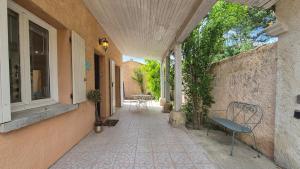 an empty hallway of a house with a window and a bench at La Santoline - Provençal break with pool in Le Thor