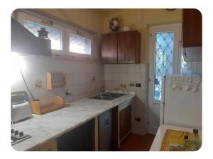 a kitchen with a sink and a refrigerator at Villa LUCCA in Altopascio