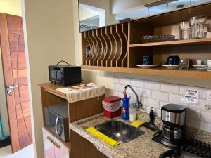 a kitchen with a sink and a counter top at Chalé 3 vista para montanha in Itatiaia +1 photo