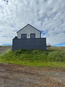 a house sitting on top of a grassy hill at Akrar guesthouse in Hella +34 photos