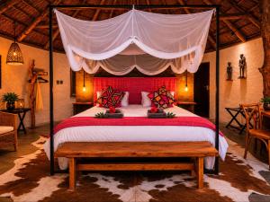 a bedroom with a large bed with a canopy at Addo African Home in Addo +38 photos