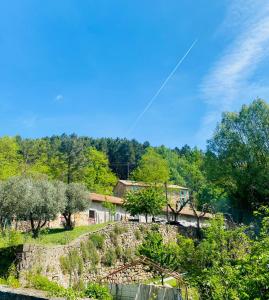 a kite flying in the sky over a river at Le cadeau bleu, duplex en Cévennes in La GrandʼCombe