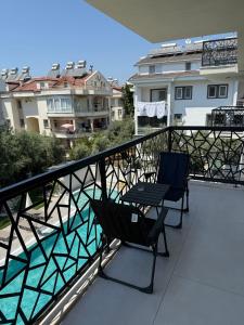 two chairs sitting on the balcony of a apartment at Fethiye Serenity Suites in Fethiye