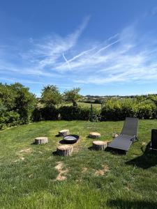 a chair and a table and some logs in the grass at Da Elio in Montacuto