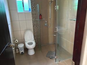 a bathroom with a toilet and a glass shower at casa la luz Orotina in Orotina +23 photos
