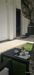 a black table in the grass in a yard at A Casa di Dody in Guidonia