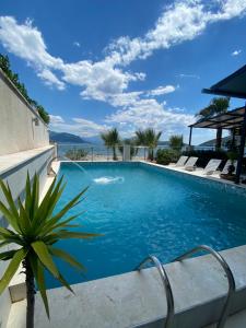 a swimming pool with a view of the ocean at Hotel Vienna in Herceg-Novi