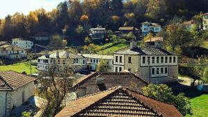 a group of houses in a town with roofs at Конак Буката in Bukata