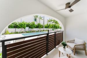 a balcony with an arched window and a swimming pool at Villa Solana - Boca Pool Hideaway in Boca Raton +38 photos