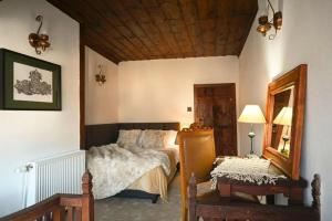 a bedroom with a bed and a mirror and a table at Конак Буката in Bukata +8 photos