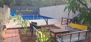 a garden with chairs and a swimming pool at Studio Serinity Cove R-2 by Mukund Sadan Arambol in Arambol +5 photos