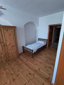 a bedroom with a bed and a wooden floor at MiMo penzion in Telč