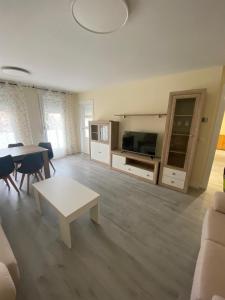 a large living room with a table and a couch at Apartamento Chicuelo in Ariza
