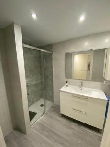 a bathroom with a sink and a shower at Apartamento Chicuelo in Ariza +12 photos
