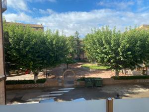a view of a courtyard with trees and a building at Apartamento Chicuelo in Ariza