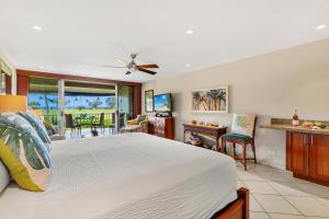 a bedroom with a bed and a living room at Maui Eldorado Condo J221 in Kaanapali