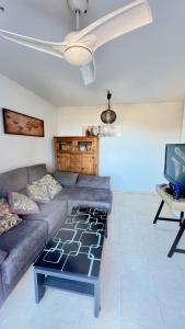 a living room with a couch and a tv at La Envía Terraza in La Envia