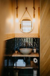 a bathroom with a sink and a mirror at Wygórowane - nowoczesne stodoły pod Tatrami in Brzegi +57 photos