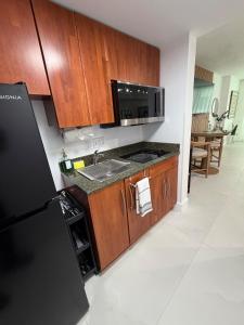 a kitchen with a sink and a refrigerator at Luxury executive Studio in Brickell in Miami