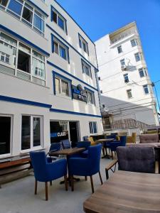 a building with chairs and tables in front of it at Blue class otel in Atakum