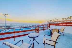 a patio with tables and chairs on the beach at Dog-Friendly Villa with Heated Outdoor Pool, Hot Tub, Streaming, Balcony, Grill in Rosarito