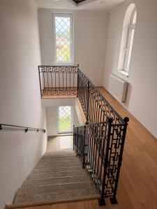 a staircase in a building with two windows at Sunny Home Digomi 7 in Tbilisi City