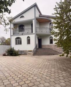 a large white building with stairs and a balcony at Sunny Home Digomi 7 in Tbilisi City