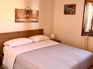 a bedroom with a bed with two pillows at Casetta IV Vico- Chianalea in Scilla