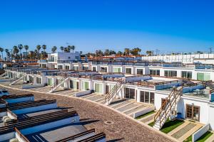 a large white building with a lot of chairs at Dog-friendly Villa with Heated Pool, Hot Tub, Streaming, Partial Ocean Views in Rosarito