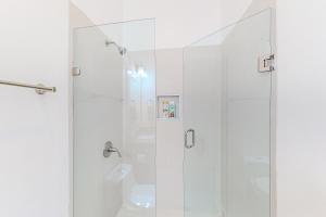 a shower with a glass door in a bathroom at Dog-Friendly Villa with Heated Outdoor Pool, Hot Tub, Streaming, Balcony, Grill in Rosarito +17 photos