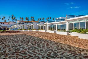 a cobblestone street in front of a building at Dog-Friendly Suite with Kitchenette, Heated Outdoor Pool, Hot Tub, Terrace, AC in Rosarito