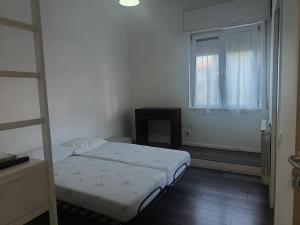a small bedroom with a bed and a window at B&B Villa AVE in Seriate