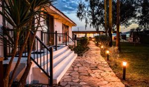 a stone walkway with lights in front of a house at Thanos Hotel in Muğla