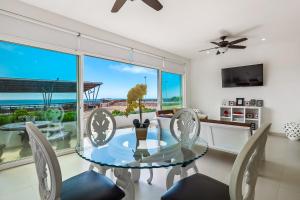 a dining room with a glass table and chairs at Bright Dog-Friendly Villa with Beach Views, Private Patio, Outdoor Pool, Kitchen in Rosarito