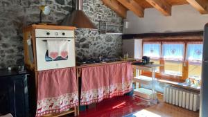 a kitchen with a stove and a sink in it at RIVER resort in Varallo