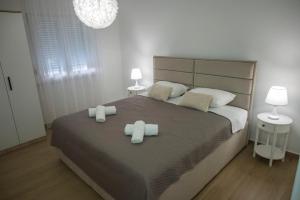 a bedroom with a large bed with two towels at Villa La Lana in Mostar +11 photos