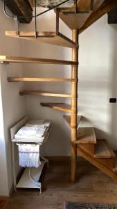 a wooden spiral staircase in a room with a table at RIVER resort in Varallo